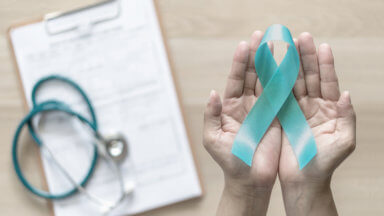 Teal ribbon awareness on woman’s hand for Ovarian Cancer, Polycystic Ovary Syndrome (PCOS) disease, Post Traumatic Stress Disorder (PTSD), Tourette’s Syndrome, Obsessive Compulsive Disorder (OCD)