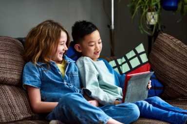 Two friends doing home school work together
