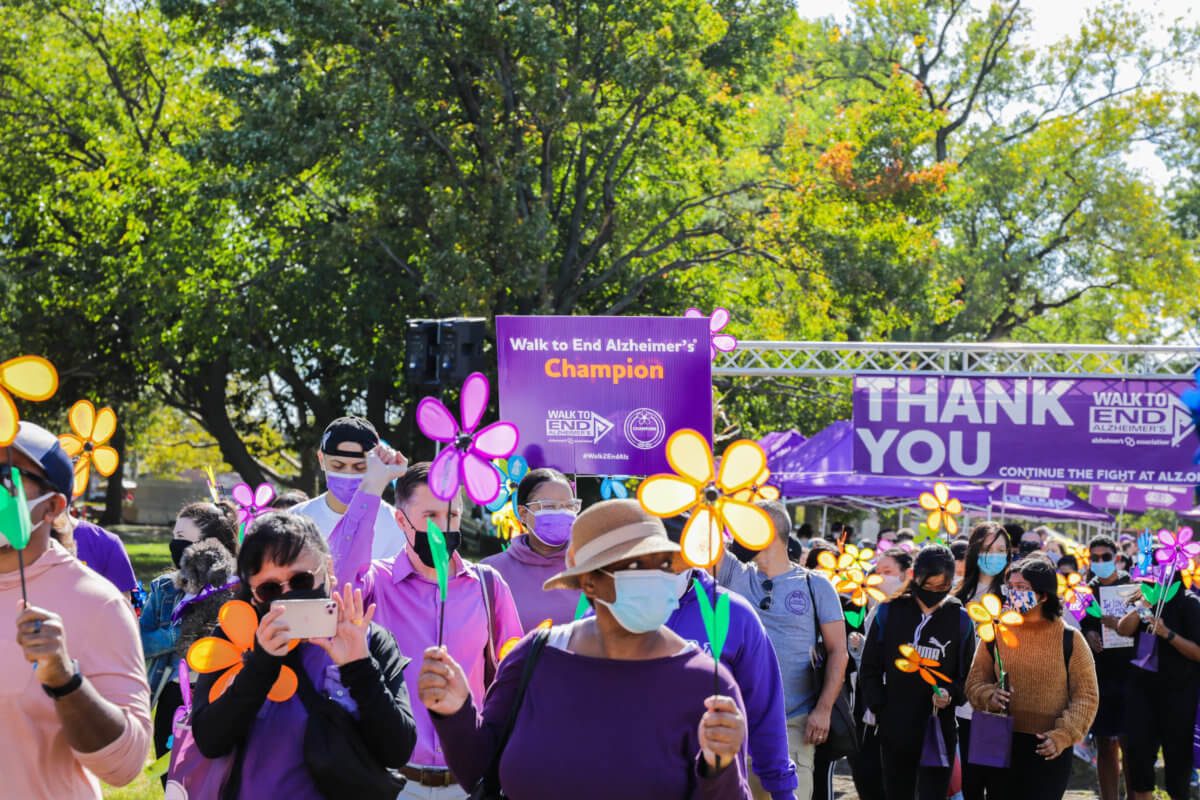 19. Walkers along the route of the National Association of University Women gather at the start line of the 2021 Queens Walk to End Alzheimer’s