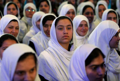 Schoolgirls listen to a speech by Afghan President Hamid Karzai during a ceremony marking the start of the school year in Kabul