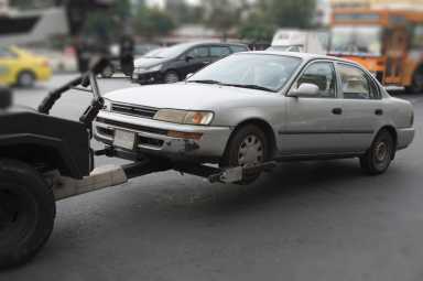 police department tow truck delivers the damaged vehicle