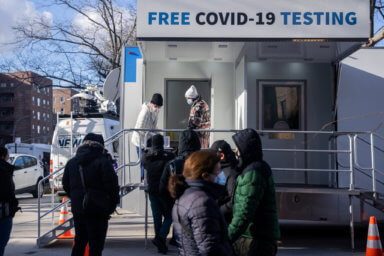 People queue at a popup COVID-19 testing site in New York