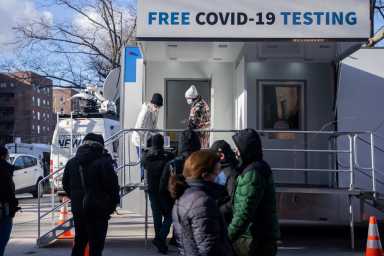 People queue at a popup COVID-19 testing site in New York
