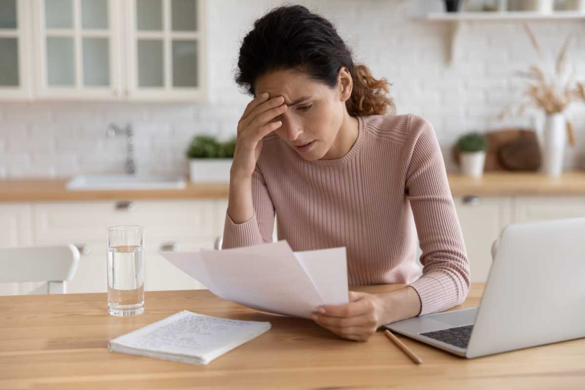 Stressed millennial female think on bank notification about business bankruptcy