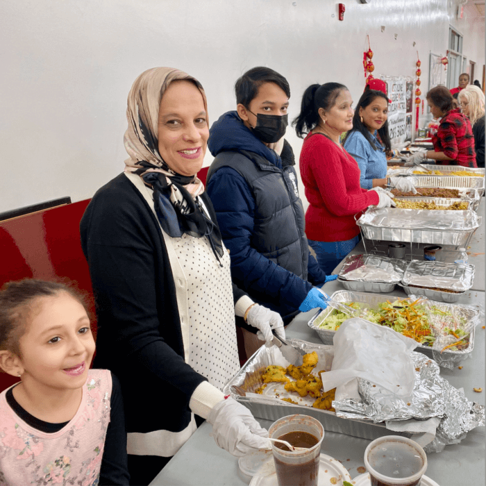 Community members serve food at the Cityline Ozone Park Civilian Patrol Lunar New Year celebration at the Deshi Senior Center.