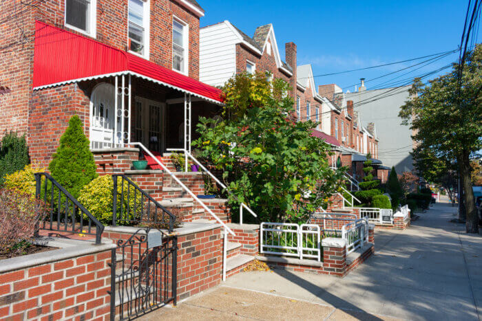 A Row of Old Brick Homes along the Sidewalk in Astoria Queens New York