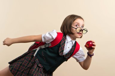 Girl in school uniform with red apple