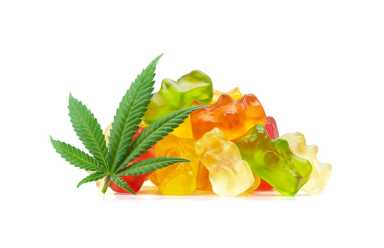 Gummy Bear Medical Marijuana Edibles (CBD or THC Candies) with Cannabis Leaf Isolated on White Background