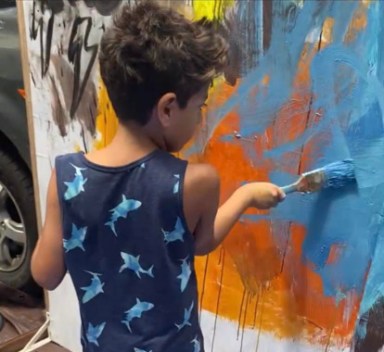 Young-student-paints-during-Foundation-for-New-American-Arts-Paint-Brushes-Not-Guns-Festival-at-The-Clemente-Cultural-and-Educational-Center-e1680724882594