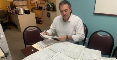Senator Addabbo reads the many constituent questionnaires that have come to his offices.