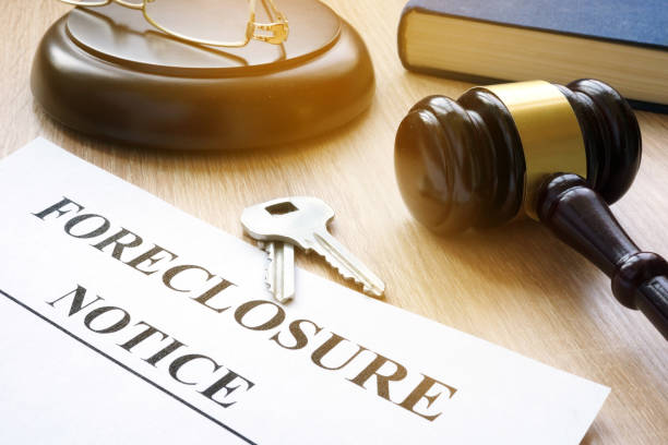 Foreclosure notice and keys on a court table.