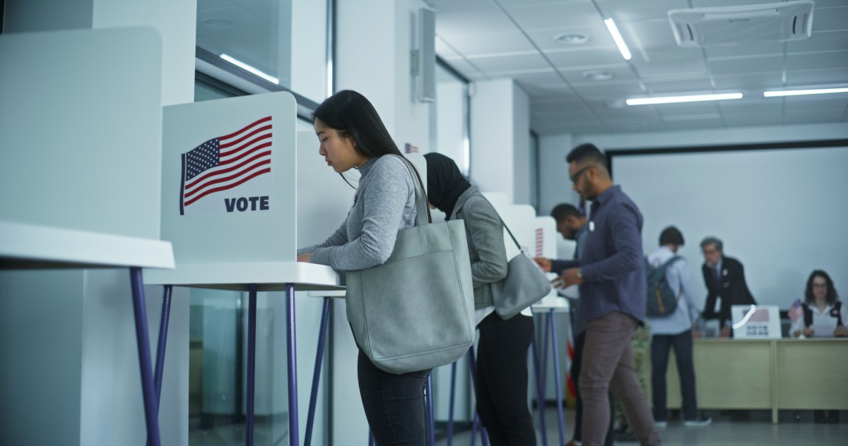 Asian woman comes to voting booths in polling station office