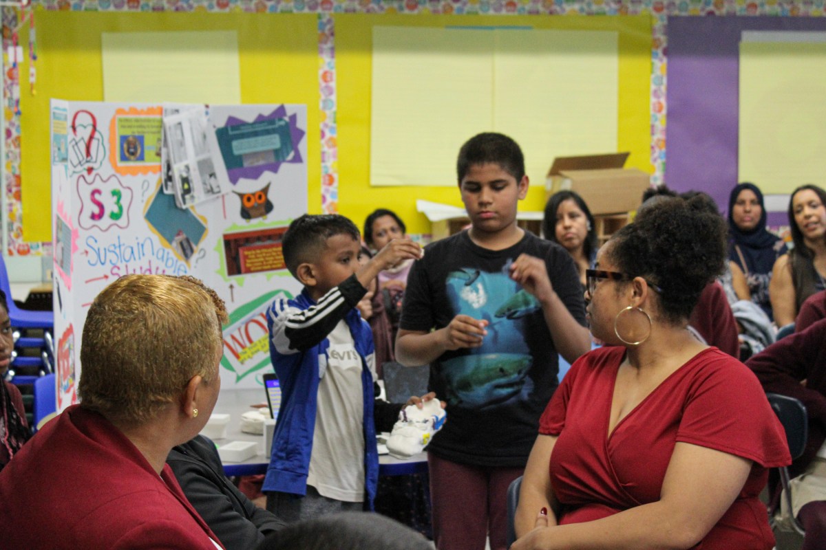 Students describe their club projects to a room full of invited guests on Leadership Day at P.S. 64Q. Photo by Anthony Medina