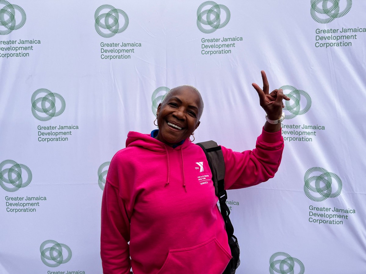 Blackwoman with short cropped hair does a peace sign with her fingers.