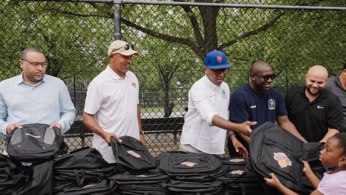 Queens Borough President Donovan Richards with backpacks