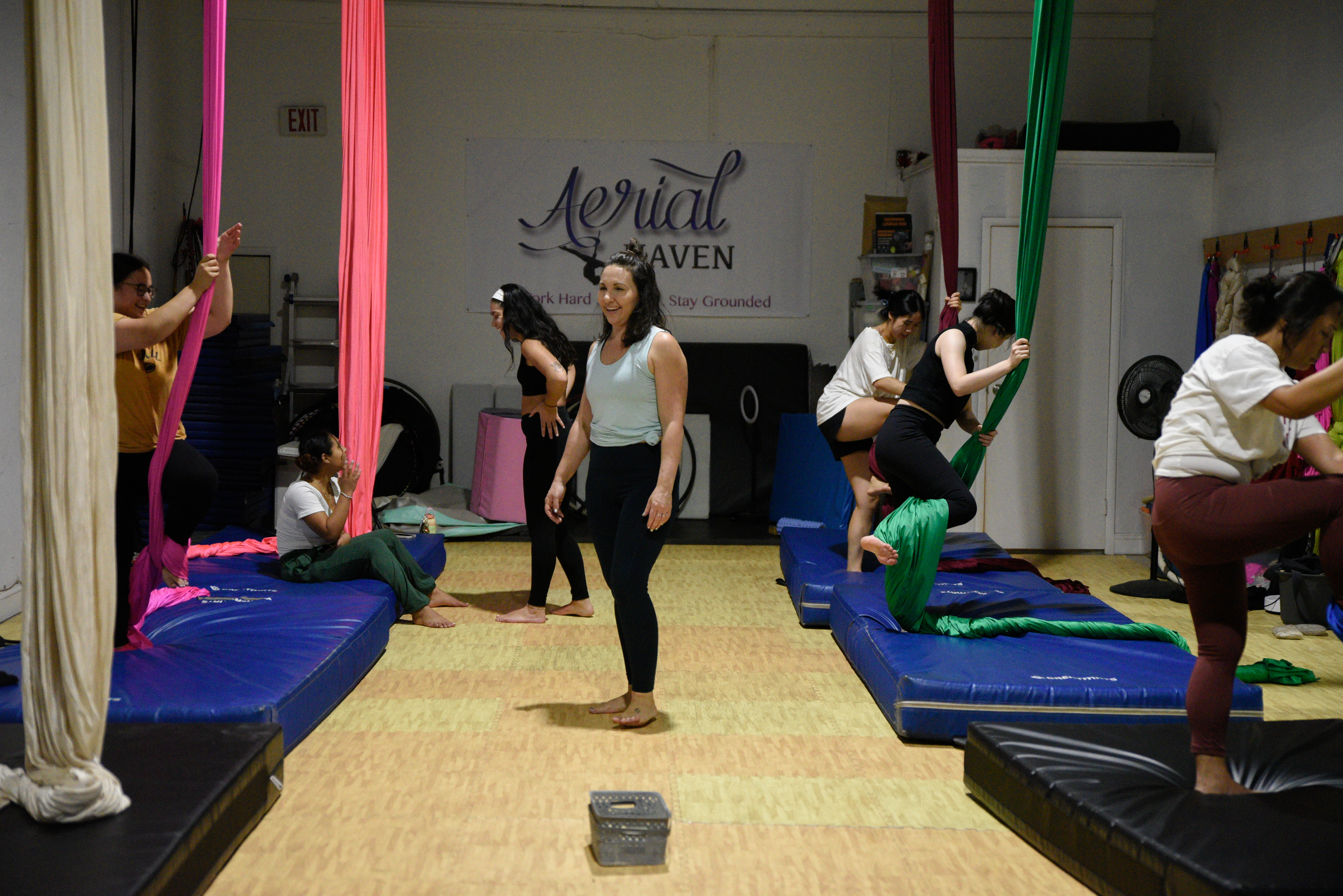 Students use silks during aerial arts class