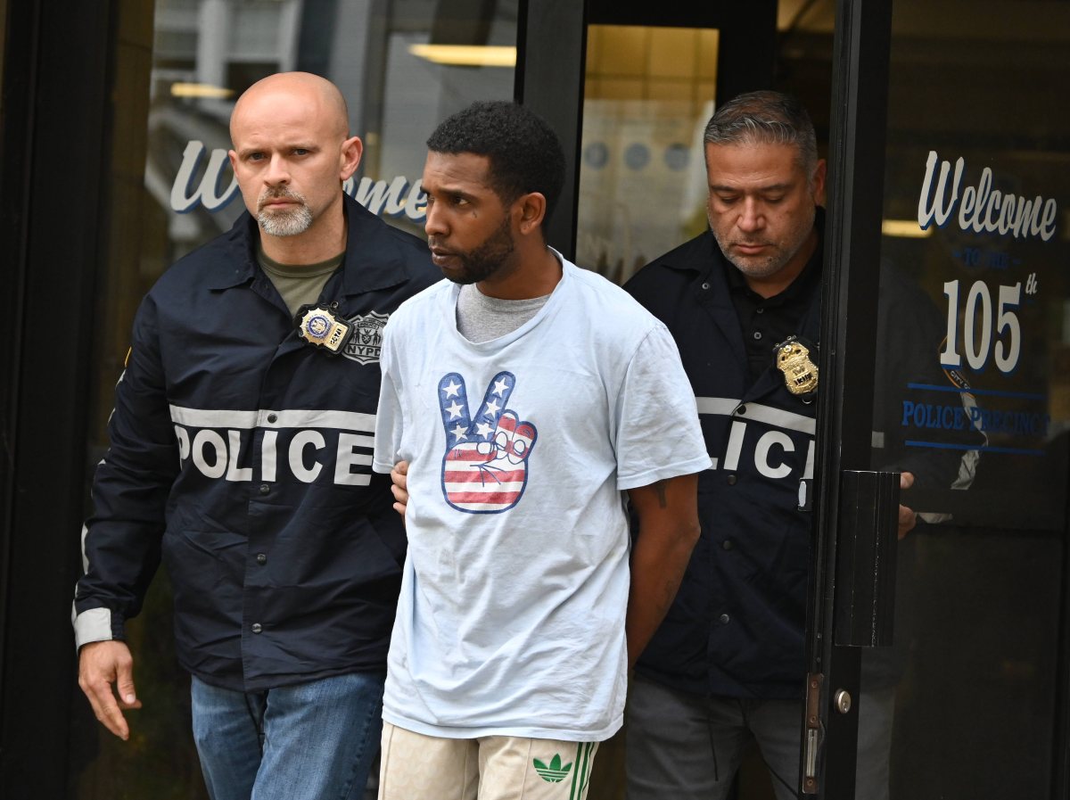 NYPD Detectives transport the suspect who was arrested in Florida.