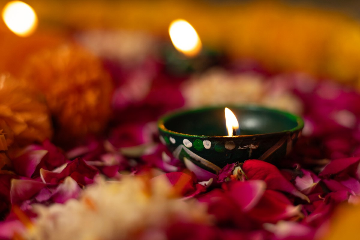 Diya oil lamp kept on Rangoli. Diwali, Festival of Lights.