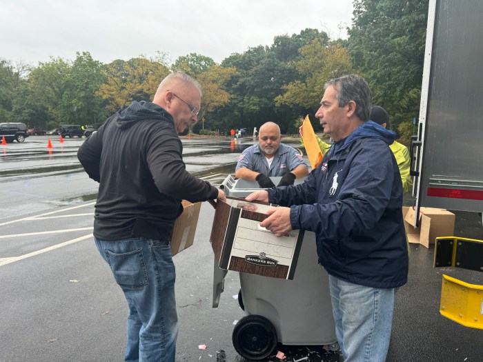 John D’Angelo, Office Manager for Senator Addabbo, assists the comstituents with shredding their paper.