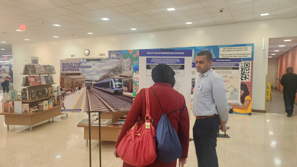 A member of the public speaks to an MTA official about the Interborough Express as part of Wednesday's open house for the 2025-29 Capital Plan. Photo: Shane O'Brien