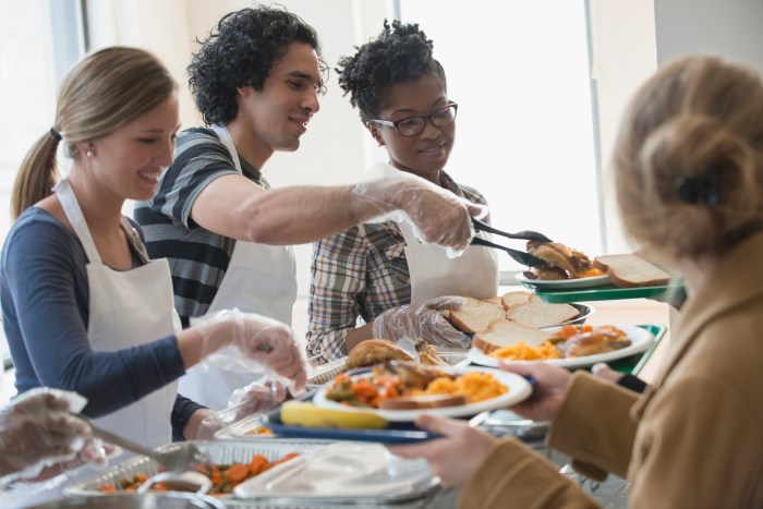 Volunteers serving food in cafeteria