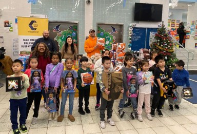 Students at PS 24 pose with their new toys following last week's giveaway. Photo: Office of Council Member Sandra Ung.