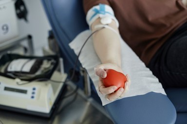 Hand of woman holding soft ball donating blood