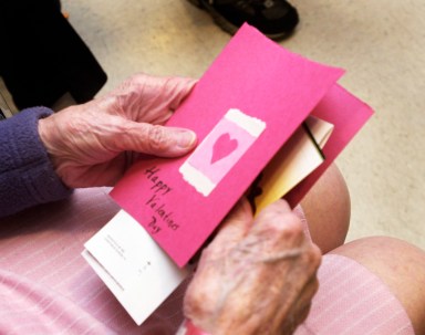 Audrey Hall, a resident at the Maine Veteran’s Home, in Scarborough, examines Valentine’s Day cards