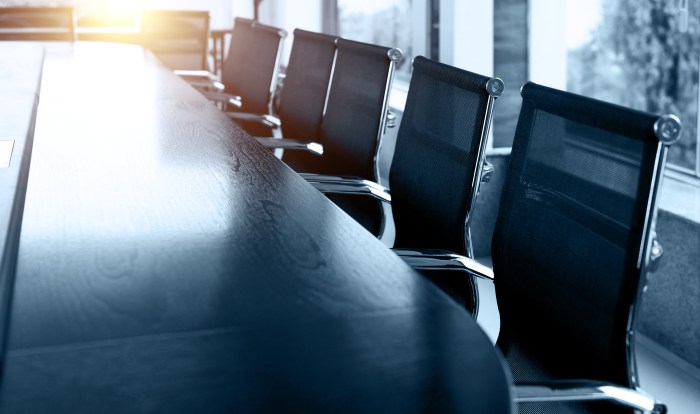 Conference table and chairs in empty meeting room