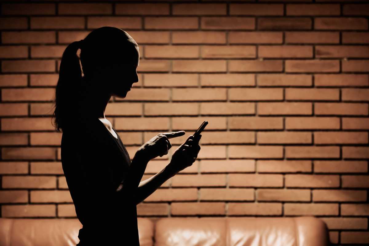 Woman typing message on her mobile phone.