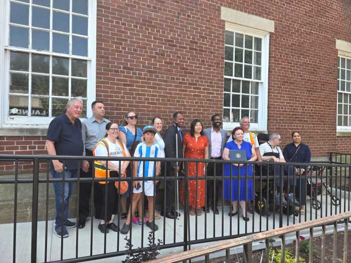 Elected officials and advocates celebrate the new ADA-compliant ramp at the Jackson Heights Post Office. Photo: Shane O'Brien