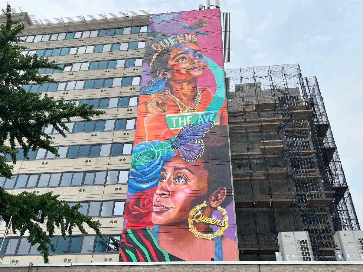 Brooklyn artist paints towering mural to Queens at new affordable housing site