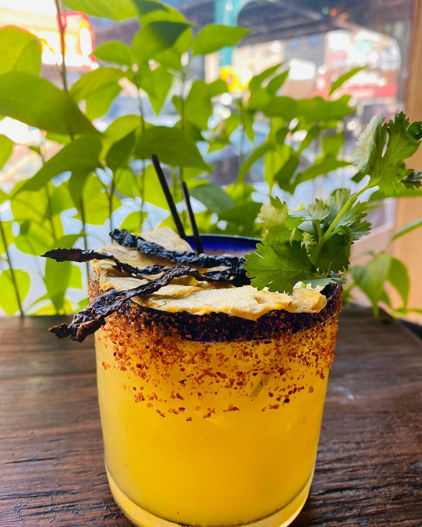 The Alpastor Margarita on a wooden countertop at Laly's Restaurant & Agaveria at Jackson Heights.