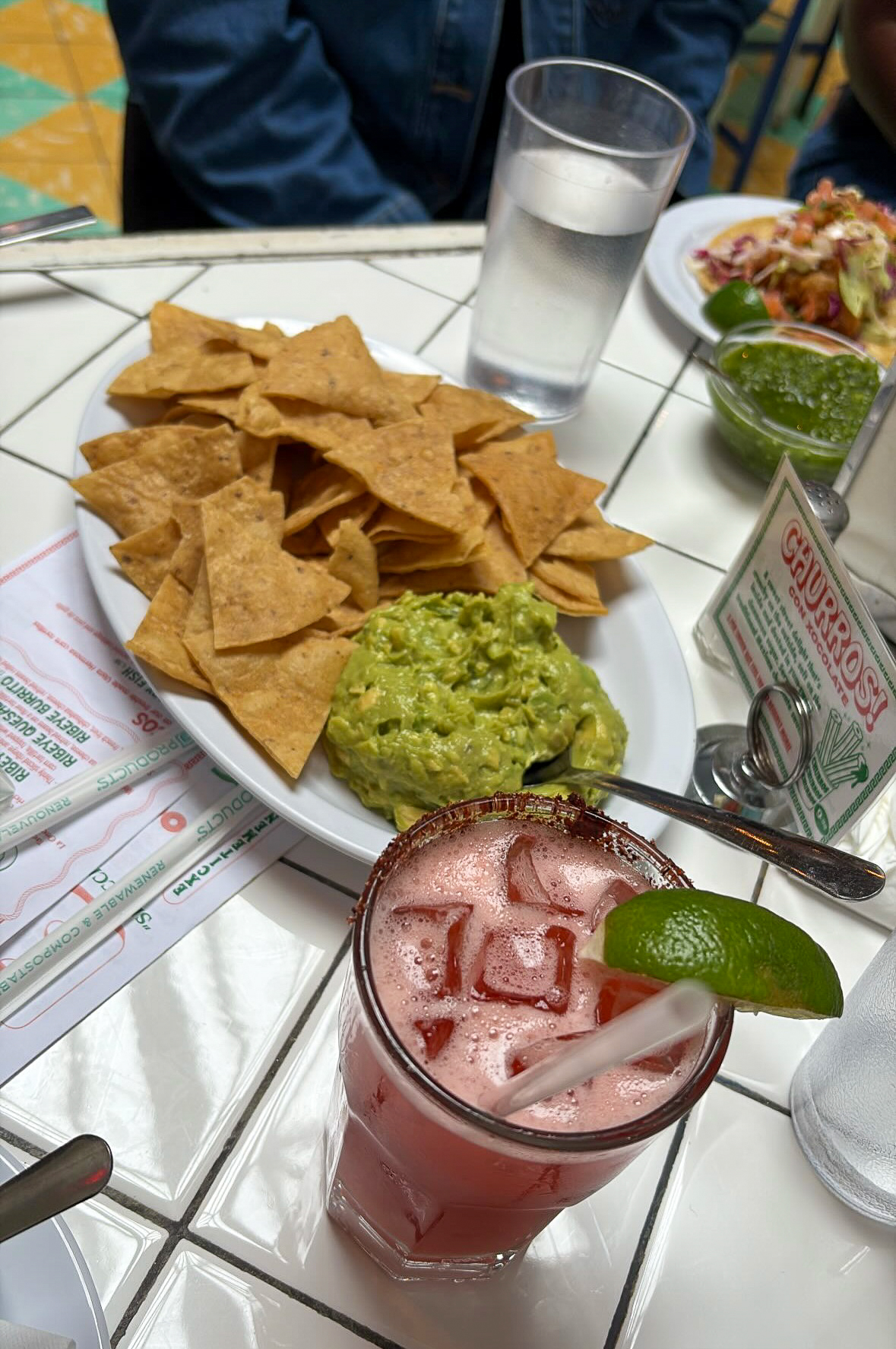 A Strawberry Mezcalita, paired with a plate of nachos and guacamole, at Tacombi in Forest Hills. 