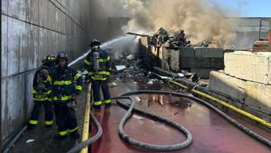 Firefighters battled a stubborn two-alarm fire that broke out in a Maspeth scrapyard on Monday morning.
