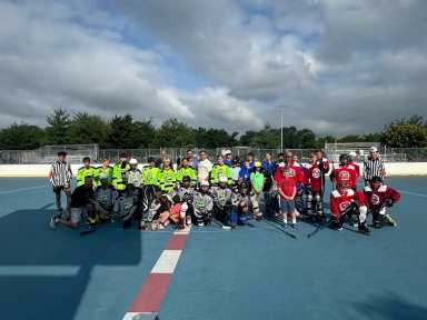 Teams from Middle Village and Long Island pose for photographs at the James Bohan Hockey Rink on Saturday. Photo courtesy of Paul Pogozelski.