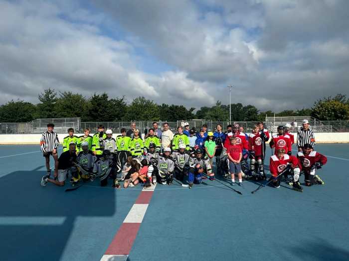 Teams from Middle Village and Long Island pose for photographs at the James Bohan Hockey Rink on Saturday. Photo courtesy of Paul Pogozelski.