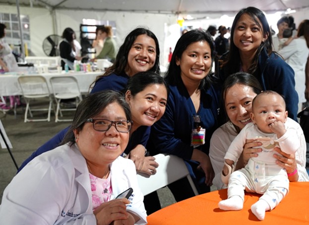 Members of Elmhurst Hospital’s Nursing team and a baby born at the hospital enjoy the celebration. Photo courtesy of NYC Health + Hospitals/Elmhurst.
