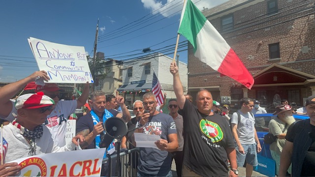 Dozens of demonstrators waving American, Italian and Israeli flags gathered at 24-08 32nd St., on one side of 31st Street near Broadway, under the banner of the Italian American Civil Rights League.