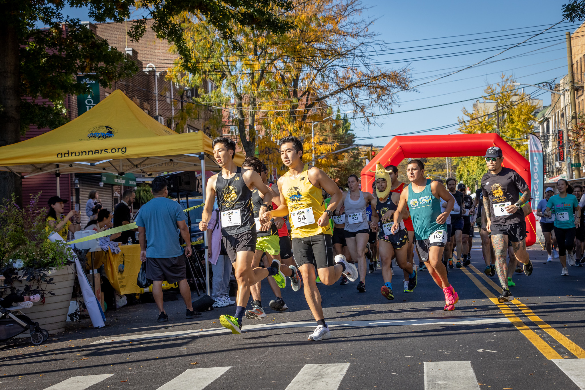 A crowd of local runners charge toward the course at the 2023 QDR Elmhurst Mile. 