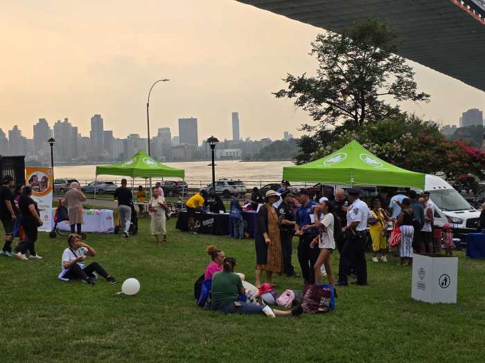 Astoria residents chat with officers from the 114th Precinct during National Night Out on Tuesday, Aug. 5. Photo: Shane O'Brien.