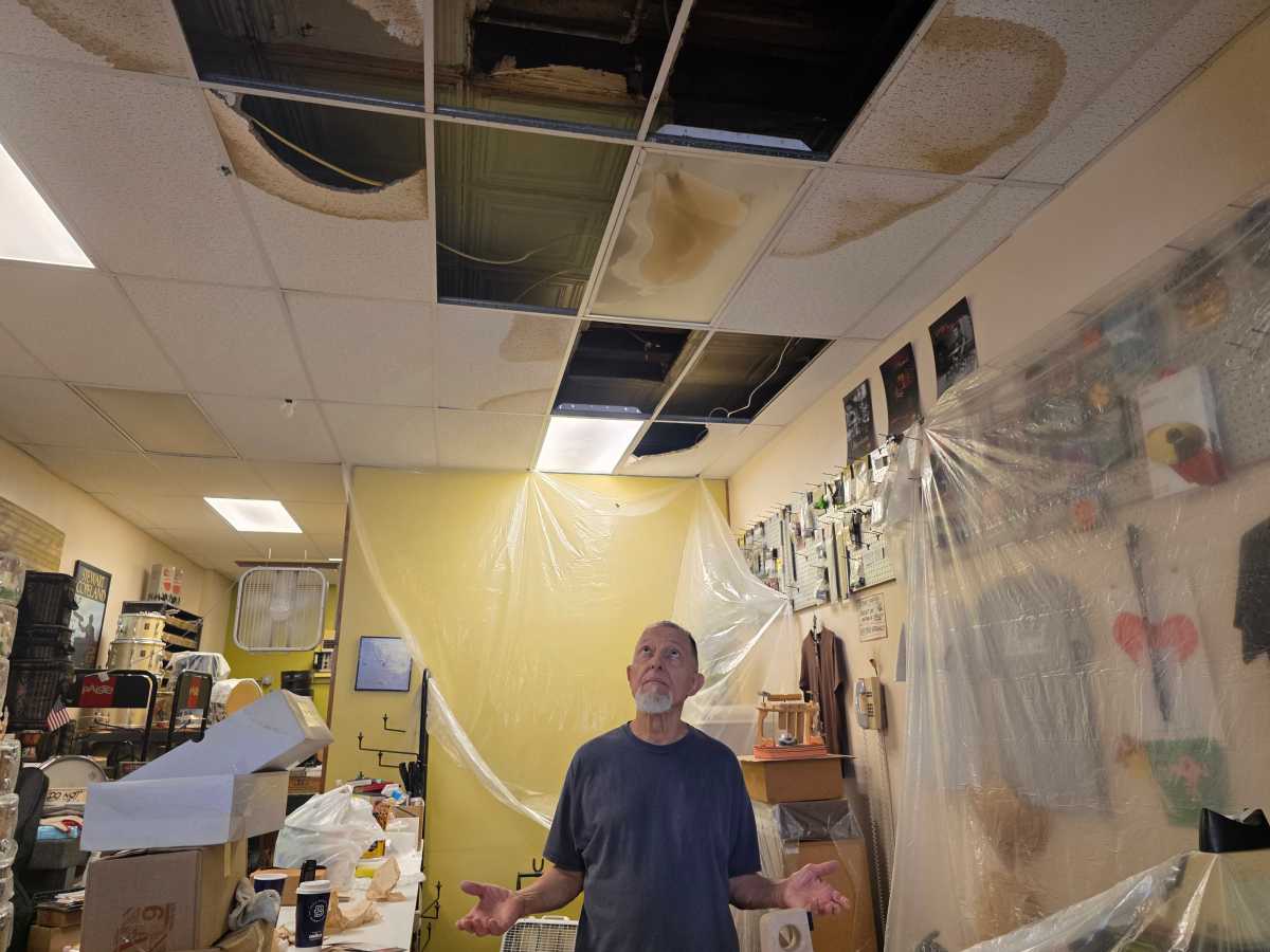 Tony Fabiano surveys the damage caused to his store by flooding at the end of July. Photo: Shane O'Brien.