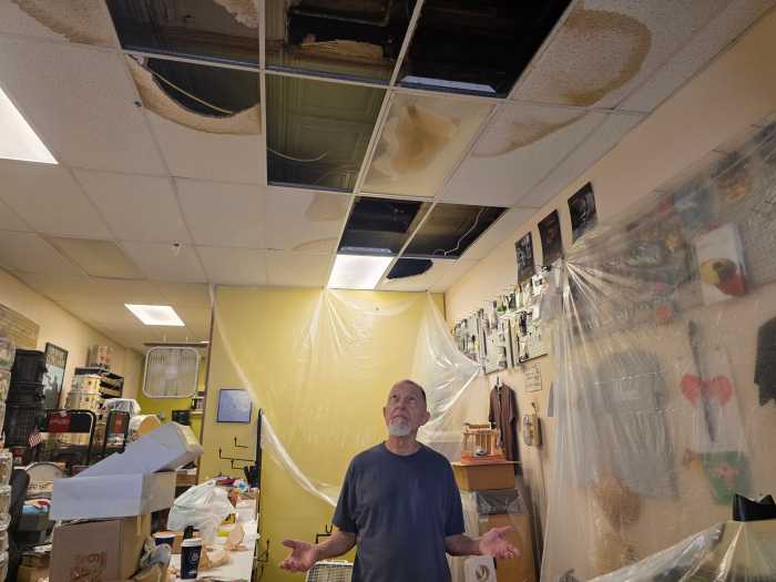 Tony Fabiano surveys the damage caused to his store by flooding at the end of July. Photo: Shane O'Brien.