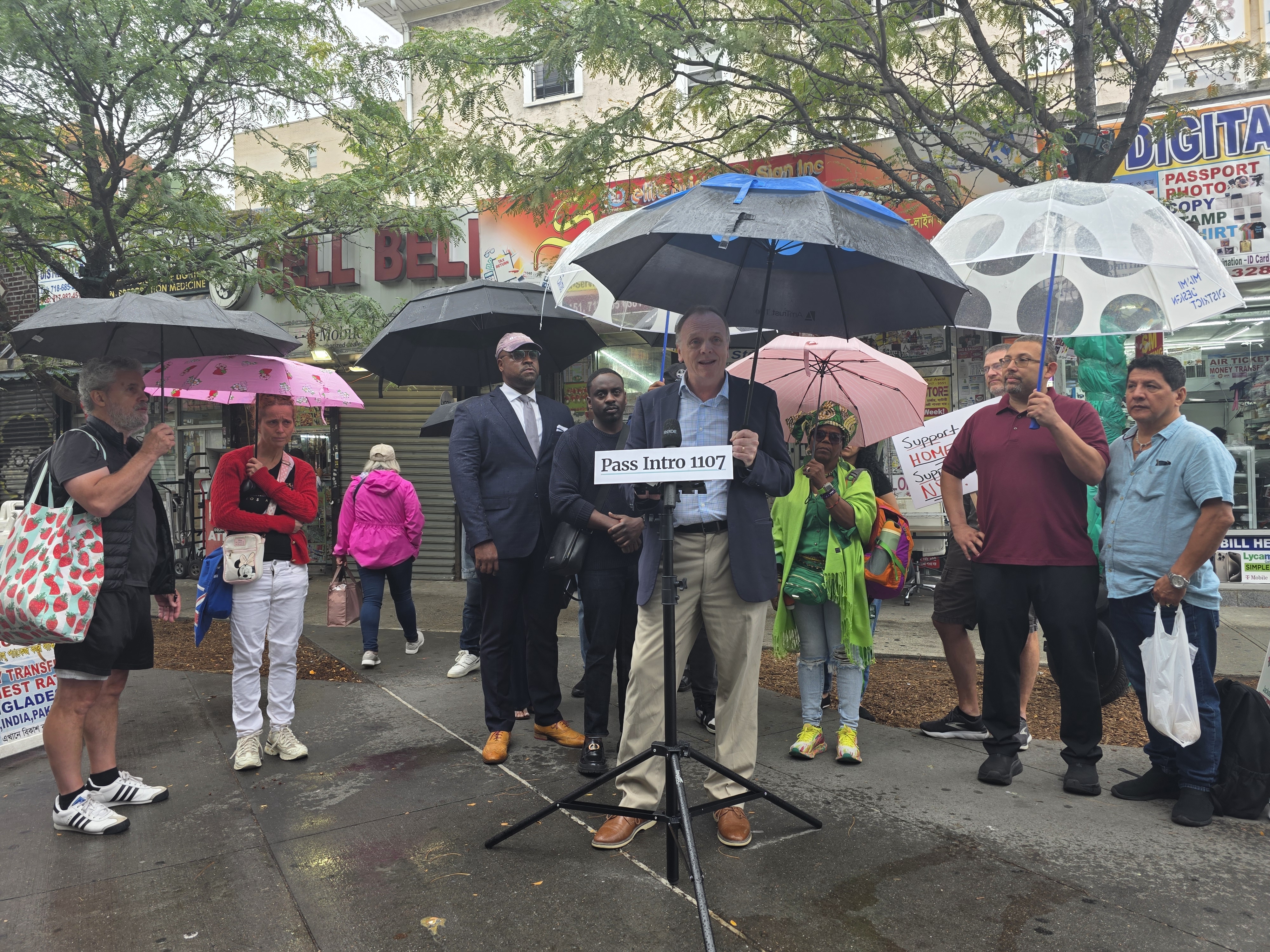Brendan Levy of the Queens Chamber of Commerce speaks in favor of Intro 1107 at Jackson Heights' Diversity Plaza. The legislation would expand flexibility for short-term rentals, such as Airbnb. Photo: Shane O'Brien.