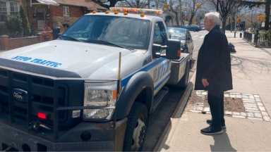 Council-Member-Robert-Holden-speaks-to-an-NYPD-office-towing-an-illegally-parked-vehicle-Photo-provided-by-Council-Member-Robert-Holdens-Office-1