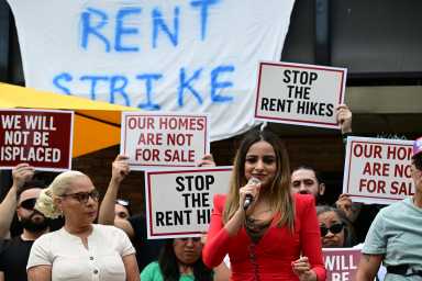 Assembly Member Jenifer Rajkumar speaks at Saturday's rally outside 56-21 Clover Pl. Also pictured: Assembly Member Maritza Dávila. Phot: Ramy Mahmoud.