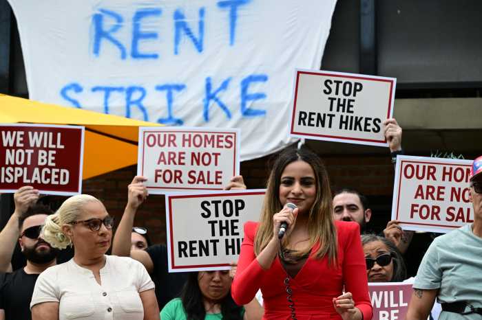 Assembly Member Jenifer Rajkumar speaks at Saturday's rally outside 56-21 Clover Pl. Also pictured: Assembly Member Maritza Dávila. Phot: Ramy Mahmoud.