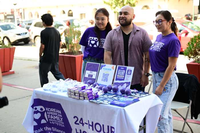 Raga poses with members of the Korean American Family Service Center at Saturday's giveaway. Photo: Ramy Mahmoud.