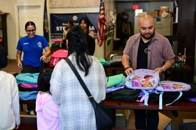Raga distributes backpacks at Saturday's event. Photo: Ramy Mahmoud.