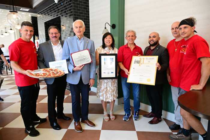 Charlie, Joe and John Troia pose with elected officials including U.S. Rep. Grace Meng, State Sen. Joseph P. Addabbo, Assembly Member Steven Raga and Council Member Robert Holden at the grand reopening of Rosa's Pizza last Friday. Photo: Ramy Mahmoud.